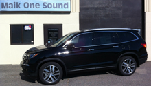 Black 2016 Honda Pilot with dark privacy window tint